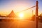 Sillhouette of a volleyball net and sunrise on the beach