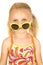 Silly blond girl wearing swimsuit and sunglasses down on nose