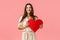 Silly and carefree, lovely alluring brunette girl in fancy dress, holding red big heart card, having best valentines day