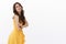 Silly happy cheerful gorgeous brunette caucasian woman, wear yellow summer dress, laughing pleased and joyful, stand