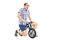 Silly young guy riding a tiny bicycle