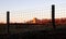 Silo and Farm Buildings Through a Fence