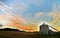 A silo on a farm at sunrise.