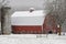 Silo and large farm building during snow flutter. New Hampshire USA