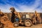 Silo-loader tractor lifts ladle with silo in deep silo trench