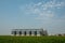 Silos in a barley field. Storage of agricultural production. In field