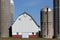 Silos and a barn against blue sky in rural United States