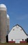 Silos and a barn against blue sky in rural United States