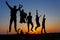 Silouette of friends jumping on the sand in Thar desert
