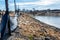 silt fence at a construction site with straw covered dirt and retention pond in background