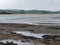 Silt on the seabed at low tide. The shallow sea bay. Seaside landscape
