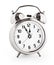 Silver alarm clock showing twelve hours with clipping path