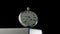 Silver antique pocket watch on a stand rotating on a black isolated background. Round gray retro clock with a white dial