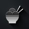 Silver Asian noodles in bowl and chopsticks icon isolated on black background. Street fast food. Korean, Japanese