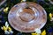 silver baptismal bowl adorned with flowers