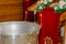 Silver baptismal font with burning candles in a church.