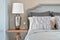 Silver base table lamp with clock and classic gorgeous bedding