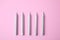 Silver birthday candles on pink background