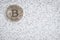 Silver Bitcoin on black and white binary 1 and 0 background