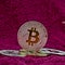 Silver bitcoin coin on pink scene