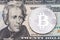 SIlver bitcoin on twenty dollas banknote.
