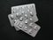 Silver Blister Packs of Treatment Pills on Black Background