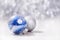 Silver and Blue Christmas ornaments balls on glitter bokeh background with space for text. Xmas and Happy New Year