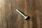 Silver bolt on wooden background