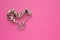 Silver bracelet in heart shape unique decoration and gems on pink background. Best gift for girl for womans day and saint