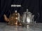 Silver and Brass Teapots Black Background Marble Table