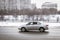 Silver bright Toyota Corolla E140 driving outside on a winter street