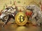 Silver bull and bear standing near generic Bitcoin cryptocurrencies. Stock charts in the background. 3D illustration