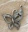 Silver Butterfly Pendant with Shiny Clear Rhinestones on Textured Background