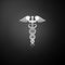 Silver Caduceus medical symbol icon isolated on black background. Medicine and health care concept. Emblem for drugstore