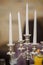 silver candlestick with white candles on a table in a banquet hall