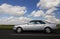 Silver car and cloudy sky