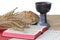 Silver chalice, bible, bread on white background