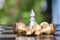 A silver chess piece on a chess board surrounded by a pile of golden pawn pieces