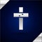 Silver Christian cross icon isolated on dark blue background. Church cross. Vector