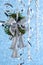 Silver christmas garland hanging on a ribbon on a blue background with bokeh