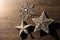 Silver Christmas tree star decorations flat lay on wood