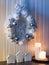 Silver christmas wreath with decorations, candles and lodges