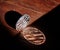 Silver coin of digital crypto currency with the symbol of Litecoin on a wooden background, close-up, macro