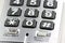 Silver cordless phone keypad closeup