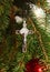 Silver cross with body of Jesus Christ on Christmas tree