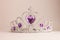 Silver crown with violet heart diamonds isolated on light background. Purple crystal headband. Female Little miss tiara