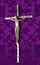 Silver crucifix placed on purple cloth. Lenten concept
