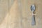 Silver cutlery, tied with a scallop, on a wooden table. Suitable as a background.