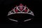 Silver diadem with hearts, rubies and diamonds isolated on black