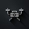 Silver Drone flying icon isolated on black background. Quadrocopter with video and photo camera symbol. Long shadow